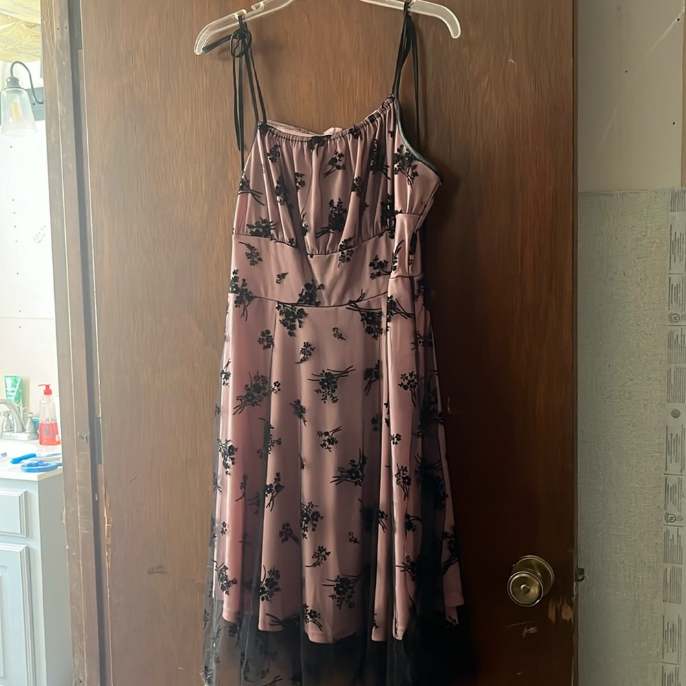 I am selling this beautiful pink with black mesh covering with black flower.